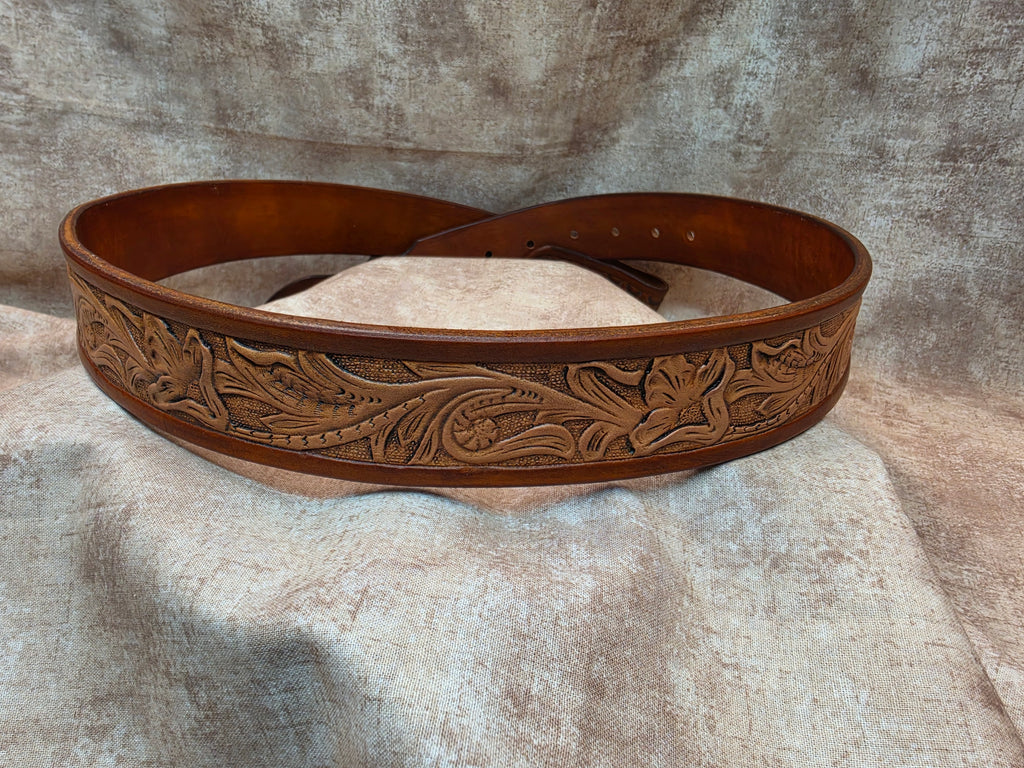 Hand tooled, golden brown, western belt with novelty tip. Size 36".