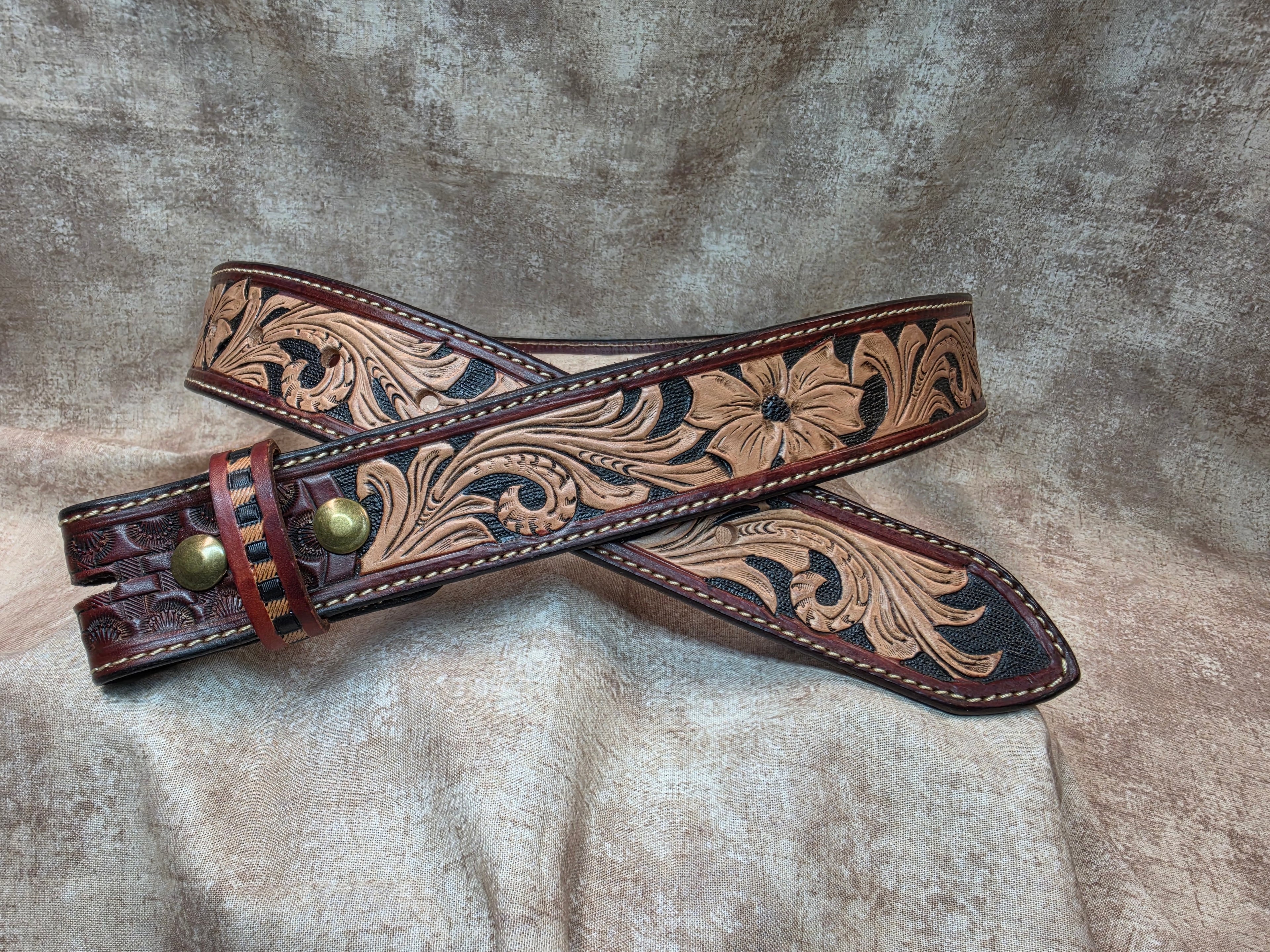 Hand tooled, mahogany colored, western belt with sewn edges. Size 34".