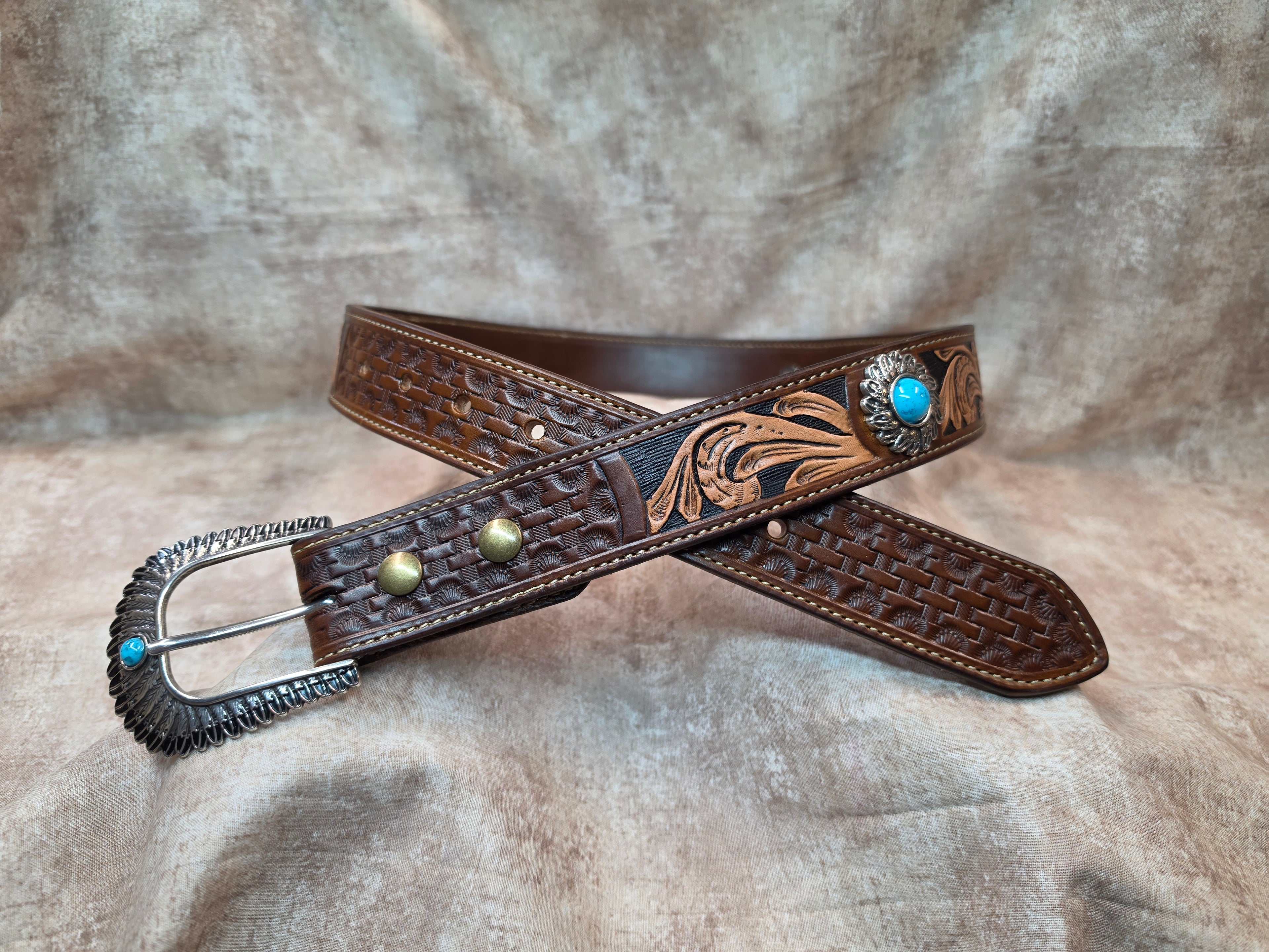Complete hand tooled, western belt with silver and turquoise colored buckle, lined back, sewn edges, tooled keeper. Size 34".