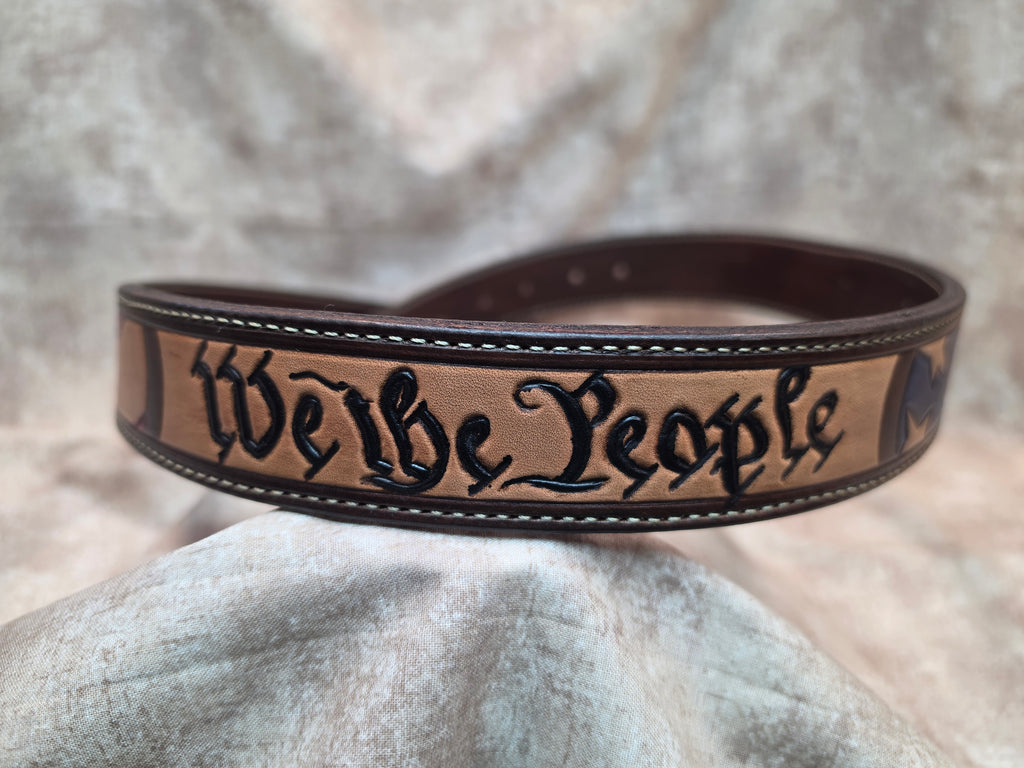Hand tooled, western belt with 'We the People' theme, including flag, lined back, sewn edges, tooled keeper. Size 37".
