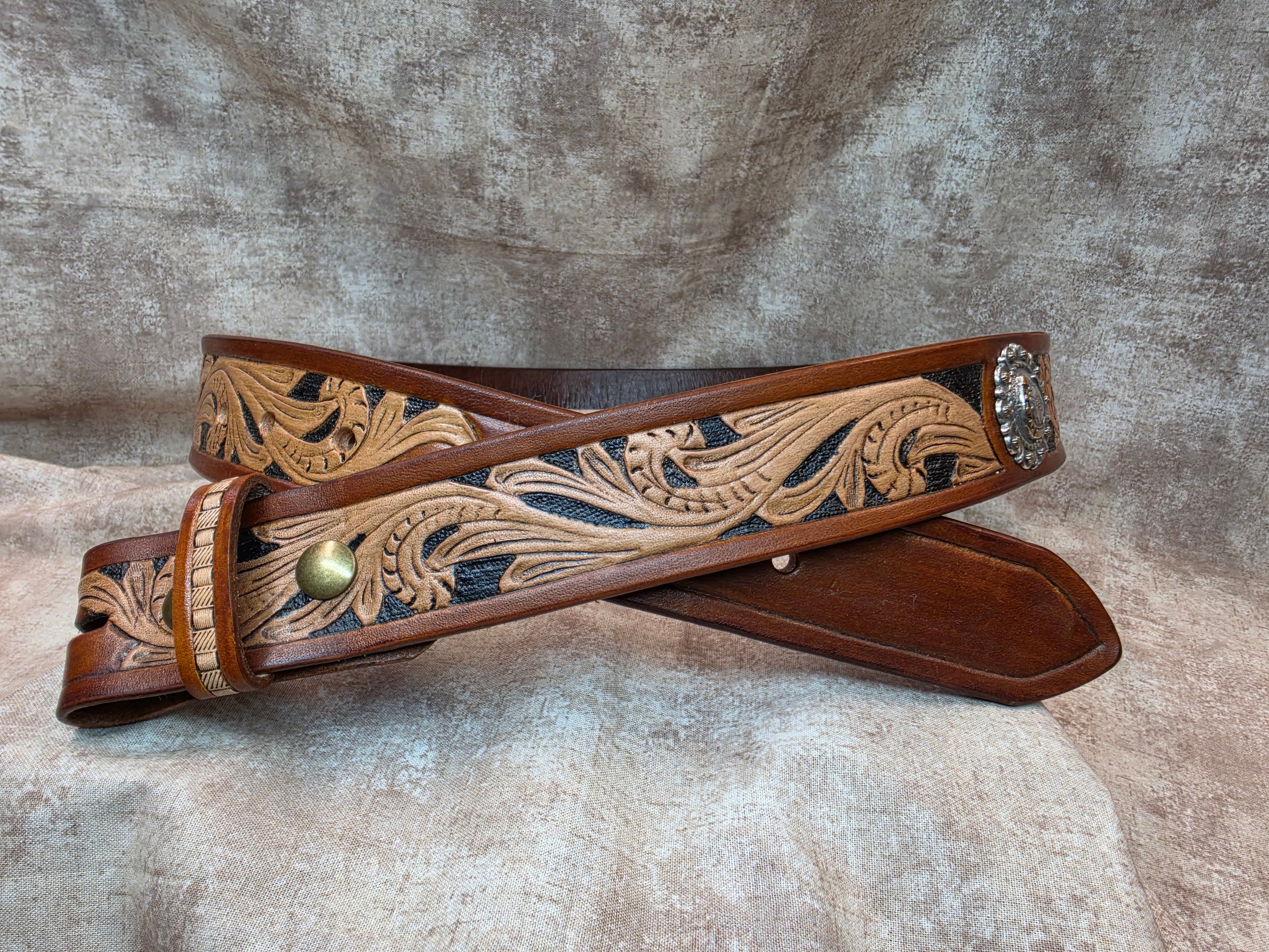 Hand tooled, golden brown, western belt with silver and gold colored horseshoe conchos. Size 38".